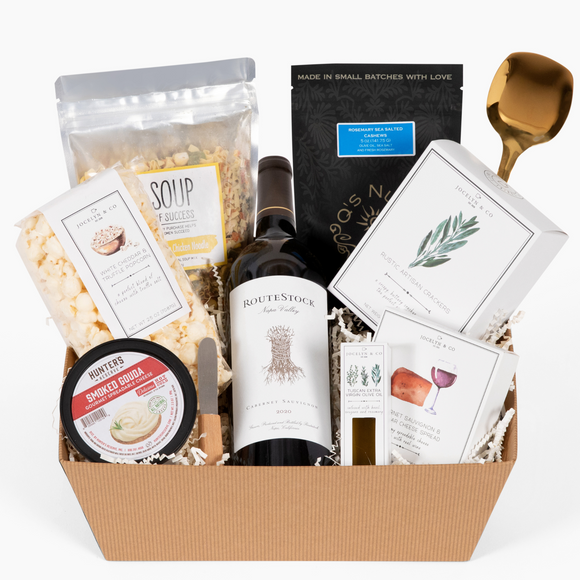 Gift basket with wine, cheese, crackers, and popcorn.